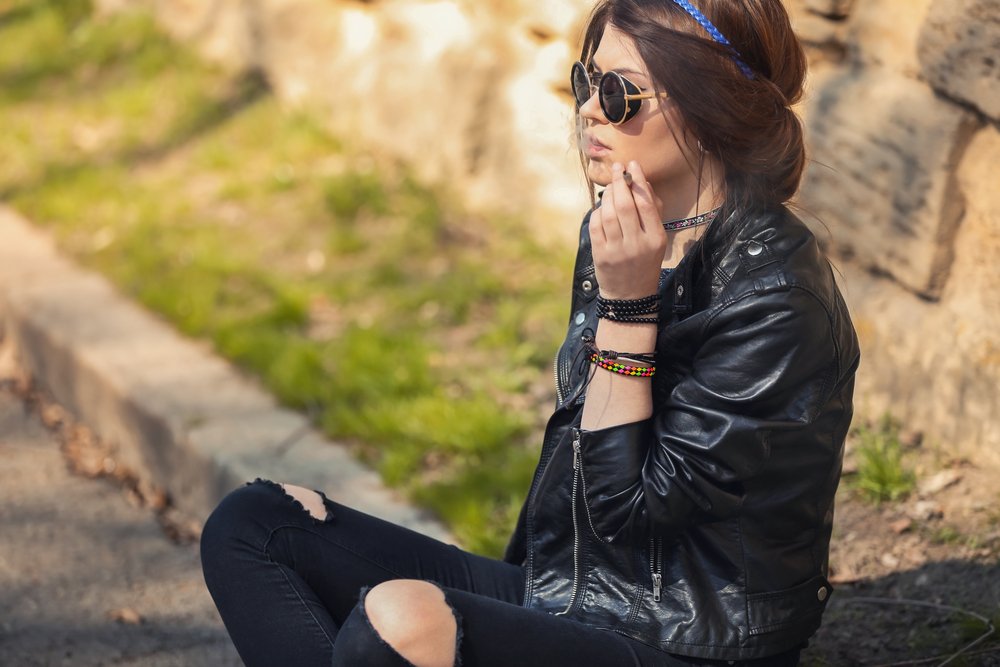 young woman smoking cannabis outdoors